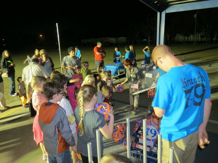 Team 79 Krunch demonstrating their robot to a crowd of students