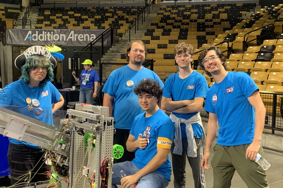 Team 79 Krunch students with their robot in the arena at the 2025 FIRST Robotics Competition