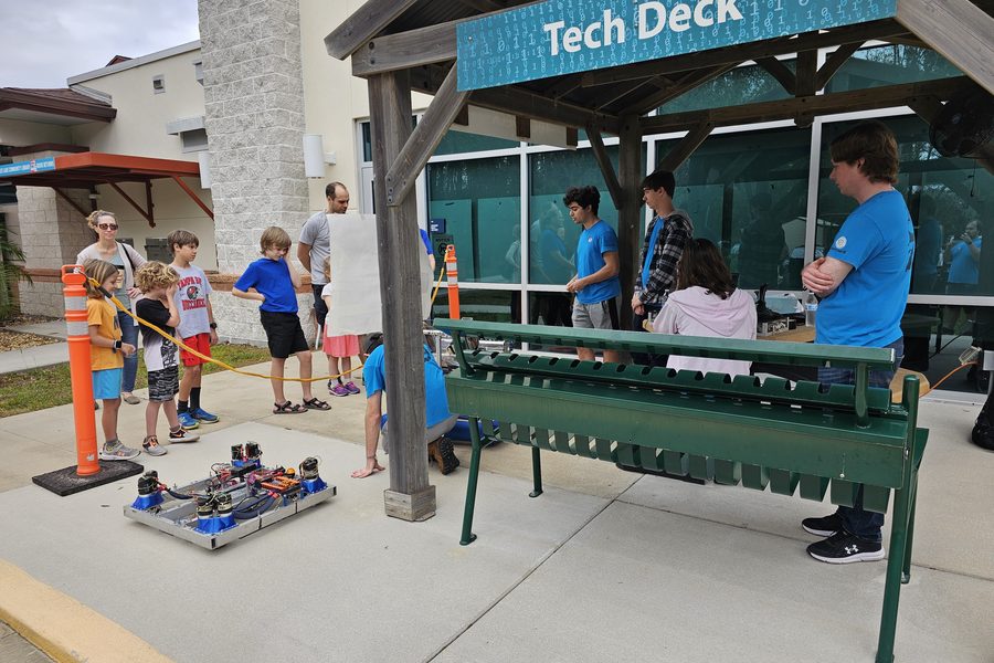 Team 79 Krunch members sharing their robots with children at a community event