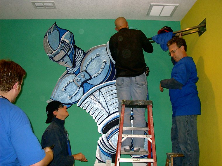 Team 79 Krunch building the robot-mural cyber-wonderland bedroom for Extreme Makeover: Home Edition