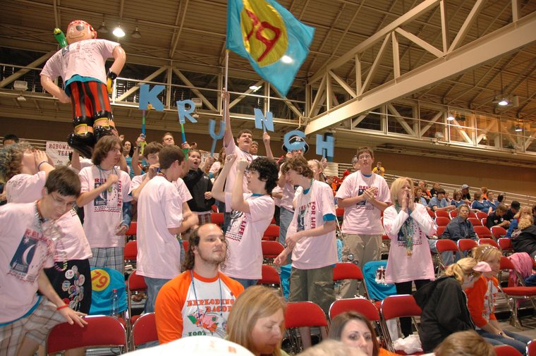 Team 79 Krunch members in Relay For Life 'Fight Cancer' shirts cheering at a competition