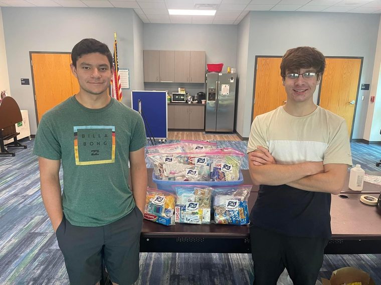 Team 79 Krunch members with bags of donated supplies collected for families in Ukraine