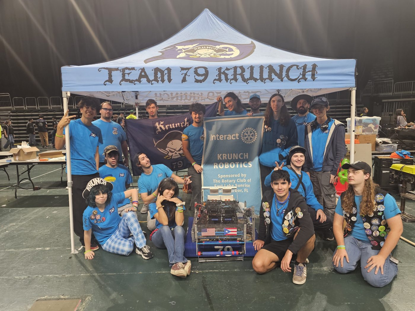 The full Team 79 Krunch team gathered under their banner with the competition robot at the 2026 South Florida Regional