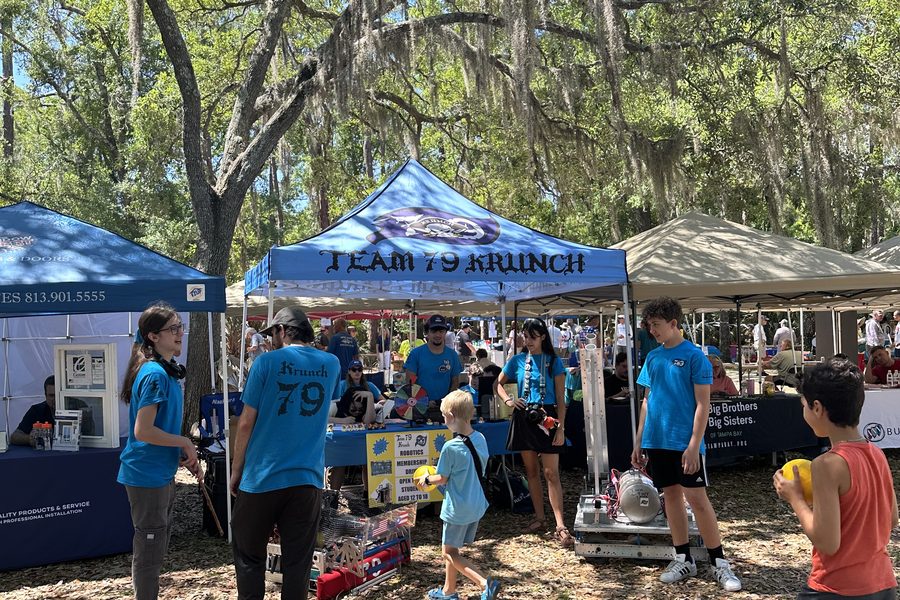 Team 79 Krunch engaging the community at their booth during the Rotary Club's Cruisin' the Park car show