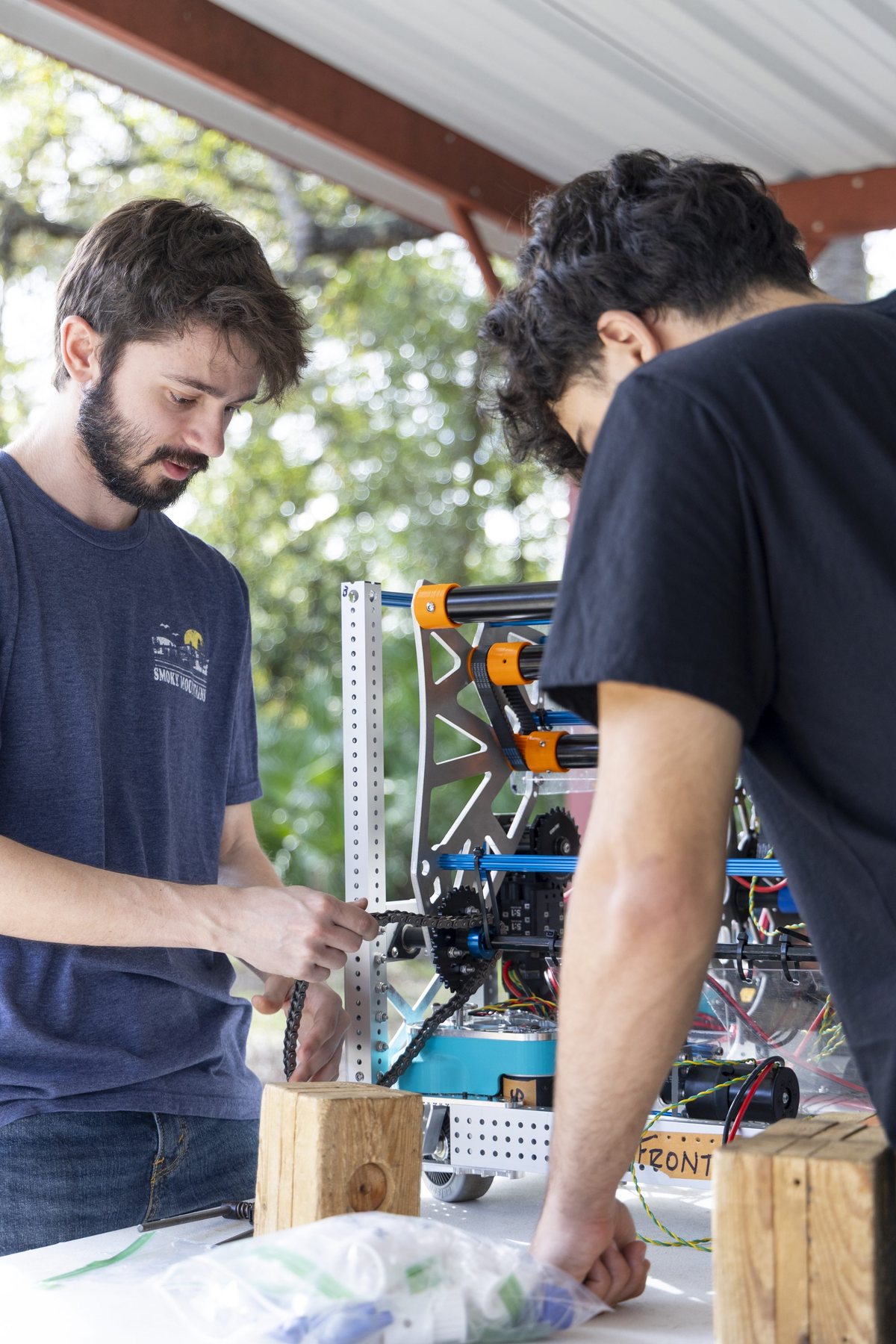 A Team 79 Krunch mentor and student building the competition robot together